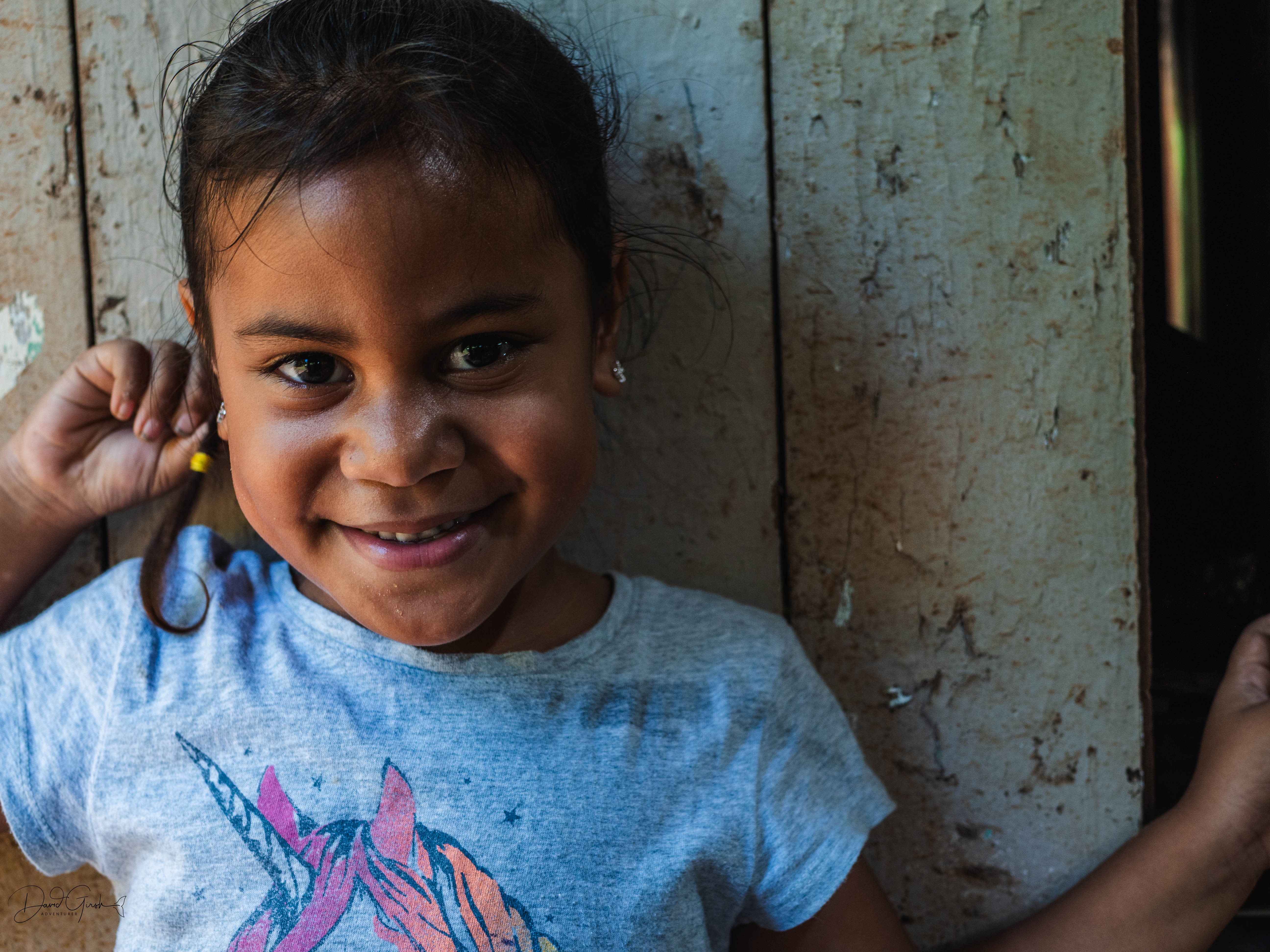 Young girl smiling in the doorway of the workshop