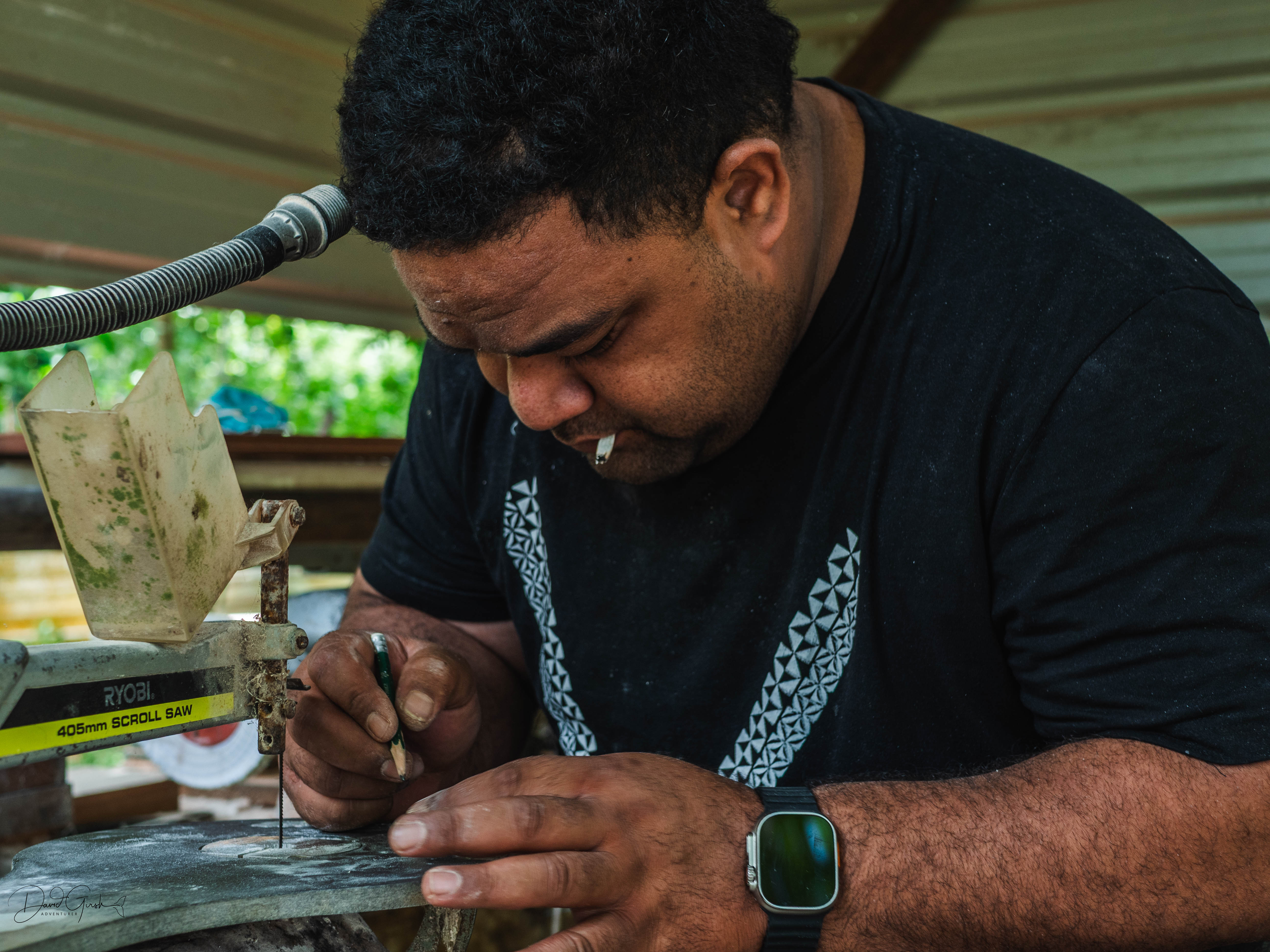 One of the brothers working at the scroll saw, cutting precise lines through bone