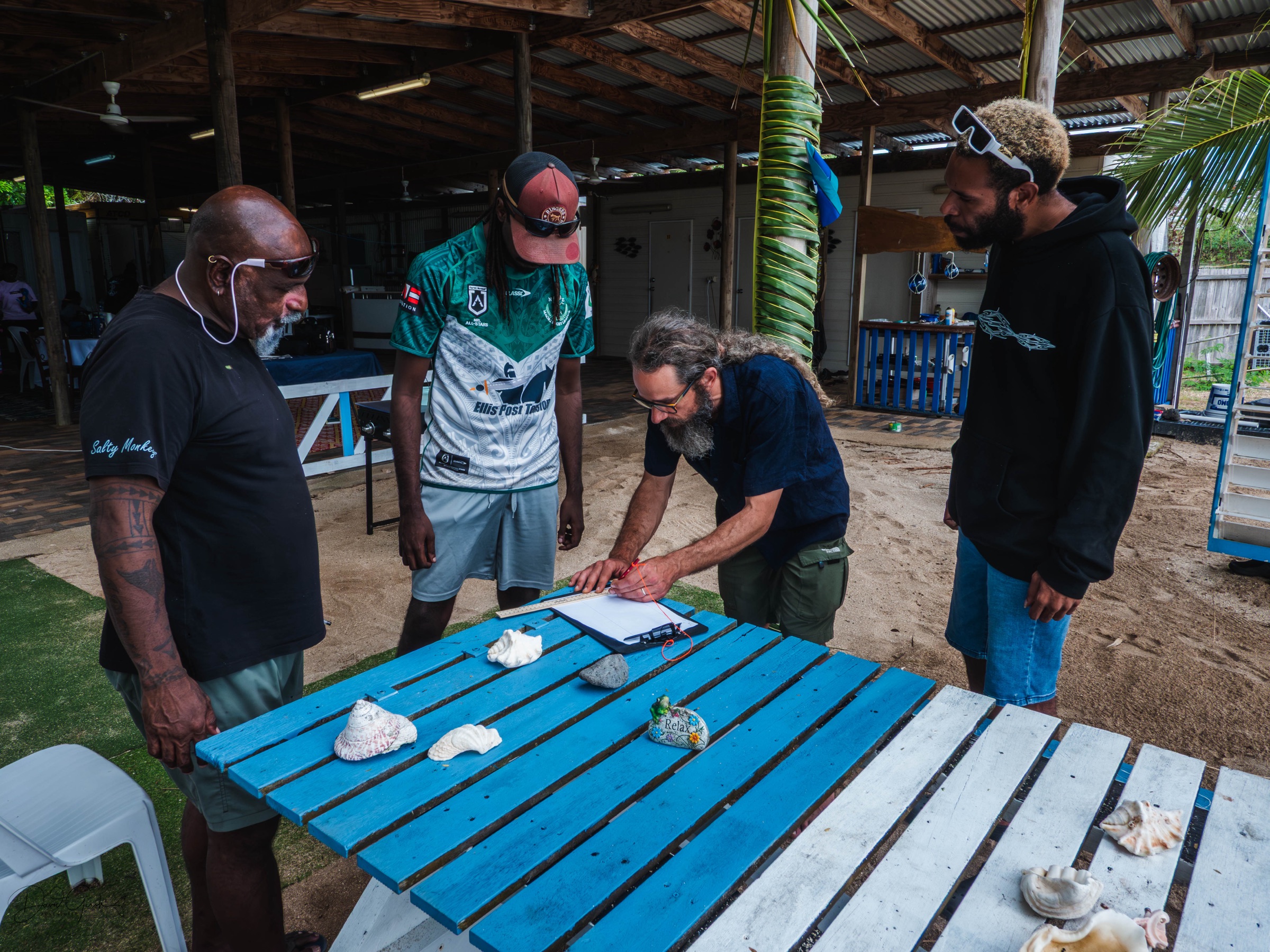 Examining shells and stones on Mer Island