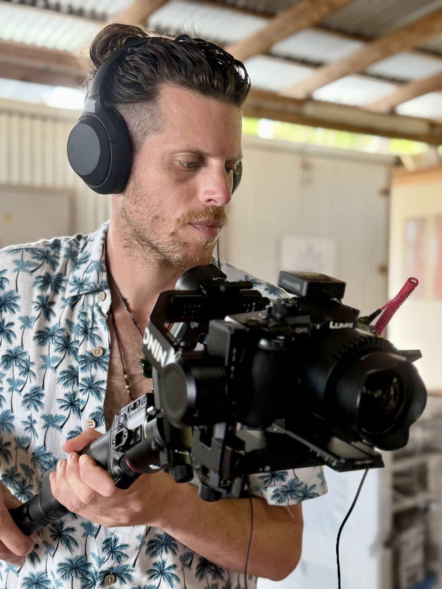 David Girsh wearing headphones while operating a rigged camera with boom mic